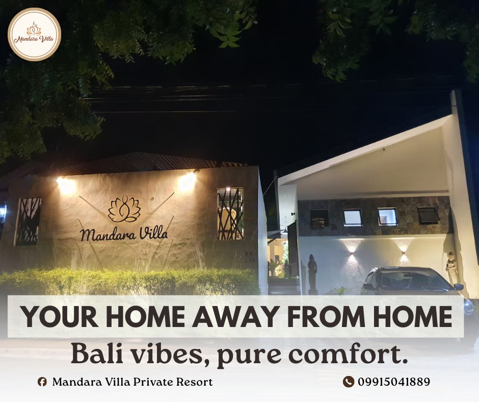 Mandara Villa night entrance — a closer view of the illuminated lotus and Mandara Villa script sign on the textured wall
